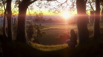 Movie still from “Maquia: When the Promised Flower Blooms” (2018), directed by Jong Heo – A woman sitting on a hill looking out at the sunset; Extreme Wide shot, Low angle