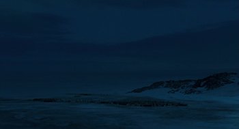 Movie still from “March of the Penguins” (2005), directed by Luc Jacquet – A view of a body of water at night time; Extreme Wide shot, Low angle