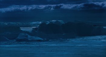 Movie still from “March of the Penguins” (2005), directed by Luc Jacquet – A view of a large body of water at night time; Extreme Wide shot, High angle