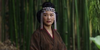 Movie still from “Marco Polo” (2014), created by John Fusco – A woman in a traditional chinese outfit with a bamboo background; Close Up shot, Over the shoulder angle