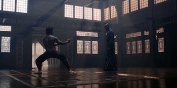 Movie still from “Marco Polo” (2014), created by John Fusco – Two men are practicing martial arts in an empty room; Wide shot, Low angle