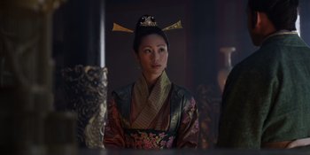 Movie still from “Marco Polo” (2014), created by John Fusco – A woman in a traditional asian dress with a crown on her head; Medium shot, Over the shoulder angle