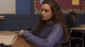 Movie still from “13 Reasons Why” (2017), created by Brian Yorkey – A woman sitting in front of a wall with a bag; Medium shot, Over the shoulder angle