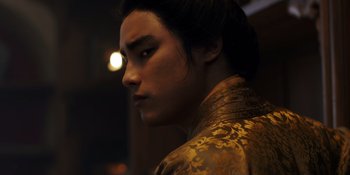 Movie still from “Marco Polo” (2014), created by John Fusco – A young man in a gold jacket looking to his left; Close Up shot, Low angle