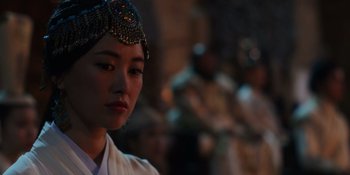 Movie still from “Marco Polo” (2014), created by John Fusco – A young woman wearing an oriental headdress; Close Up shot, Over the shoulder angle