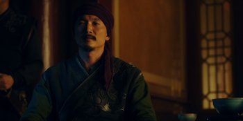 Movie still from “Marco Polo” (2014), created by John Fusco – A man with a turban is looking at the camera; Medium shot, Low angle