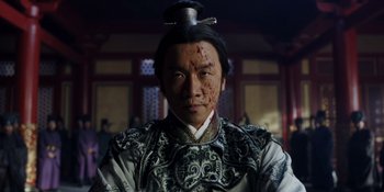 Movie still from “Marco Polo” (2014), created by John Fusco – A man with a shaved head is wearing an oriental costume; Close Up shot, Low angle