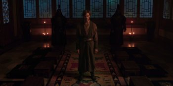 Movie still from “Marco Polo” (2014), created by John Fusco – A man in a robe standing in a room with candles; Wide shot, High angle