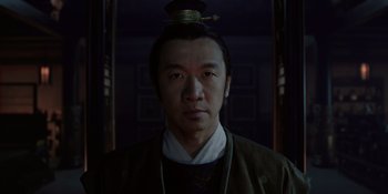 Movie still from “Marco Polo” (2014), created by John Fusco – A man with a hat on his head is standing in a dark room; Close Up shot, Low angle