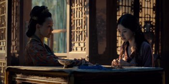 Movie still from “Marco Polo” (2014), created by John Fusco – Two women sitting at a table in front of each other; Medium shot, Over the shoulder angle
