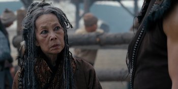 Movie still from “Marco Polo” (2014), created by John Fusco – A woman with dreadlocks is looking into the distance; Close Up shot, Over the shoulder angle