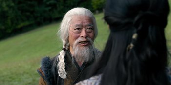 Movie still from “Marco Polo” (2014), created by John Fusco – An old man with a long white beard talking to another man; Close Up shot, Over the shoulder angle