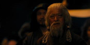 Movie still from “Marco Polo” (2014), created by John Fusco – An old man with long white hair and a beard; Close Up shot, Over the shoulder angle