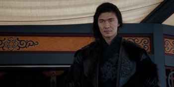 Movie still from “Marco Polo” (2014), created by John Fusco – A man with long black hair wearing a black outfit; Close Up shot, Over the shoulder angle
