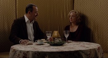 Movie still from “Margaret” (2011), directed by Kenneth Lonergan – A man and a woman sitting at a dinner table; Medium shot, Over the shoulder angle