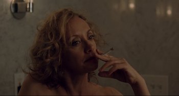 Movie still from “Margaret” (2011), directed by Kenneth Lonergan – A woman is smoking a cigarette while looking at the camera; Close Up shot, Over the shoulder angle