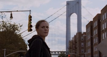Movie still from “Margaret” (2011), directed by Kenneth Lonergan – A woman standing in front of a suspension bridge; Close Up shot, Low angle