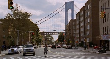 Movie still from “Margaret” (2011), directed by Kenneth Lonergan – A woman crossing a street in front of a bridge; Extreme Wide shot, Low angle