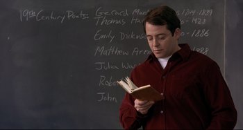 Movie still from “Margaret” (2011), directed by Kenneth Lonergan – A man standing in front of a chalkboard reading a book; Close Up shot, Over the shoulder angle