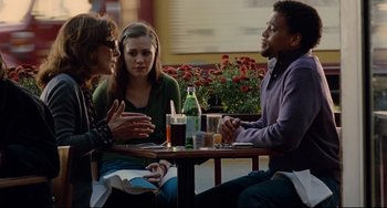 Movie still from “Margaret” (2011), directed by Kenneth Lonergan – A group of people sitting at a table with drinks; Medium shot, Over the shoulder angle