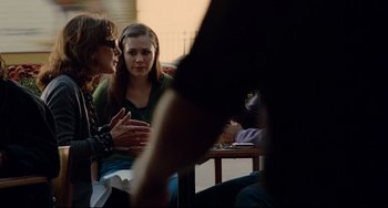 Movie still from “Margaret” (2011), directed by Kenneth Lonergan – A group of people sitting at a table talking to each other; Medium shot, Over the shoulder angle
