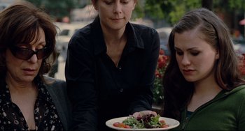 Movie still from “Margaret” (2011), directed by Kenneth Lonergan – A woman holding a plate of food with lettuce and tomatoes; Close Up shot, Over the shoulder angle