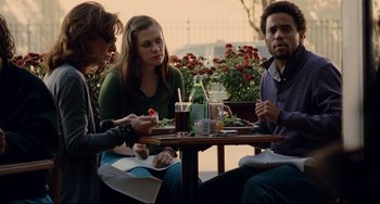 Movie still from “Margaret” (2011), directed by Kenneth Lonergan – A group of people sitting around a table; Medium shot, Over the shoulder angle