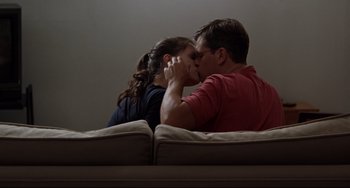 Movie still from “Margaret” (2011), directed by Kenneth Lonergan – A man and a woman kissing on a couch; Medium shot, Low angle