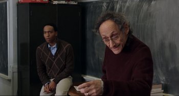 Movie still from “Margaret” (2011), directed by Kenneth Lonergan – A man sitting next to another man in a room; Medium shot, Over the shoulder angle