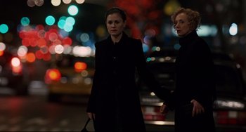 Movie still from “Margaret” (2011), directed by Kenneth Lonergan – Two women holding hands while standing on the street; Medium shot, Over the shoulder angle