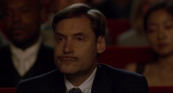 Movie still from “Margaret” (2011), directed by Kenneth Lonergan – A person wearing a suit and tie; Close Up shot, Low angle