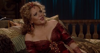 Movie still from “Margaret” (2011), directed by Kenneth Lonergan – A woman in a red dress sitting on a couch; Medium shot, Over the shoulder angle