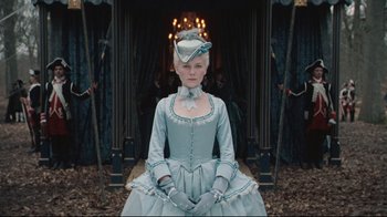 Movie still from “Marie Antoinette” (2006), directed by Sofia Coppola – A woman in a blue dress and a white hat; Medium shot, Low angle