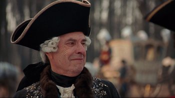 Movie still from “Marie Antoinette” (2006), directed by Sofia Coppola – An old man in a hat and a fur coat; Close Up shot, Over the shoulder angle