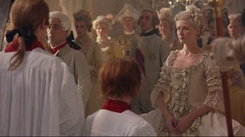 Movie still from “Marie Antoinette” (2006), directed by Sofia Coppola – A group of people dressed in period costumes; Medium shot, Over the shoulder angle