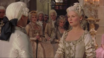 Movie still from “Marie Antoinette” (2006), directed by Sofia Coppola – A group of people dressed in period costumes; Medium shot, Over the shoulder angle