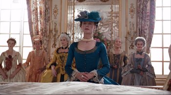 Movie still from “Marie Antoinette” (2006), directed by Sofia Coppola – A group of women in period dress sitting on a bed; Medium shot, Low angle