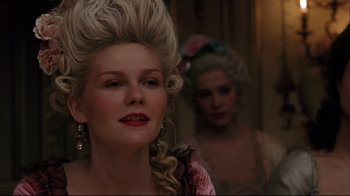 Movie still from “Marie Antoinette” (2006), directed by Sofia Coppola – A woman in a pink dress and a woman in a pink dress; Close Up shot, Over the shoulder angle