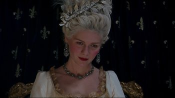Movie still from “Marie Antoinette” (2006), directed by Sofia Coppola – A woman in a white dress with a long white wig; Close Up shot, Low angle