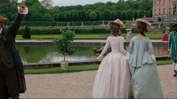 Movie still from “Marie Antoinette” (2006), directed by Sofia Coppola – Two people in period dress looking at a pond; Wide shot, Over the shoulder angle