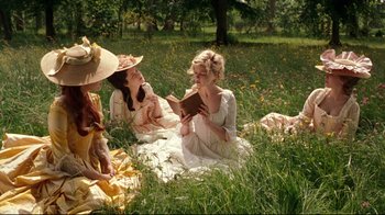 Movie still from “Marie Antoinette” (2006), directed by Sofia Coppola – A group of women sitting in the grass reading a book; Medium shot, High angle