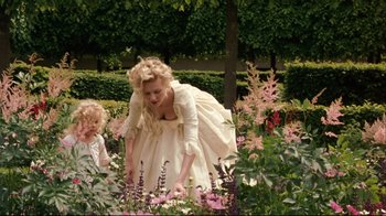 Movie still from “Marie Antoinette” (2006), directed by Sofia Coppola – A woman and a little girl in a garden of pink flowers; Wide shot, High angle