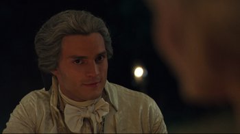 Movie still from “Marie Antoinette” (2006), directed by Sofia Coppola – A person wearing a suit and tie; Close Up shot, Over the shoulder angle