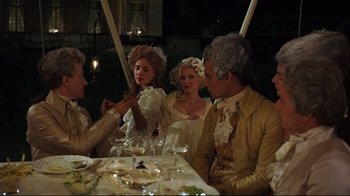 Movie still from “Marie Antoinette” (2006), directed by Sofia Coppola – A group of people sitting around a dinner table; Medium shot, High angle