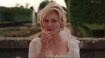 Movie still from “Marie Antoinette” (2006), directed by Sofia Coppola – A beautiful blonde haired woman wearing a white dress; Close Up shot, Over the shoulder angle