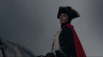 Movie still from “Marie Antoinette” (2006), directed by Sofia Coppola – A man dressed as a pirate with a red cape and hat; Close Up shot, Low angle