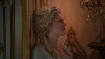 Movie still from “Marie Antoinette” (2006), directed by Sofia Coppola – A woman in a white dress with long blonde hair; Close Up shot, Over the shoulder angle