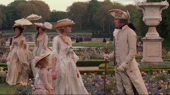 Movie still from “Marie Antoinette” (2006), directed by Sofia Coppola – A group of people dressed in period clothing; Medium shot, Over the shoulder angle