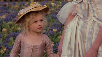 Movie still from “Marie Antoinette” (2006), directed by Sofia Coppola – A little girl wearing a dress and a hat; Close Up shot, Over the shoulder angle
