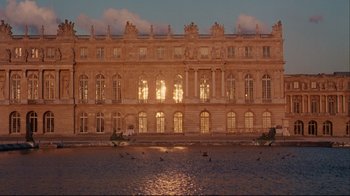 Movie still from “Marie Antoinette” (2006), directed by Sofia Coppola – A large building that has many windows on it's side; Extreme Wide shot, Low angle